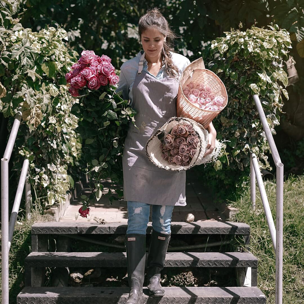 A woman carrying some farm fresh roses